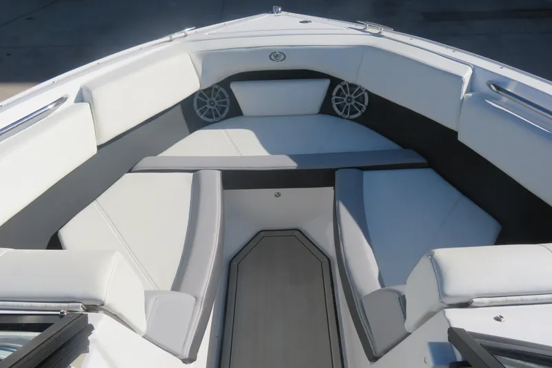 Slide: The Image of 2023 Cobalt CS22 boat interior with white cushioned seating and speaker system. - 5