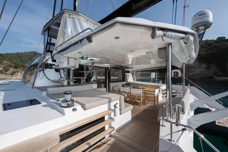 Slide: The Image of Luxury Privilege Signature 580 yacht deck, 2025 model, featuring elegant seating and dining area. - 24