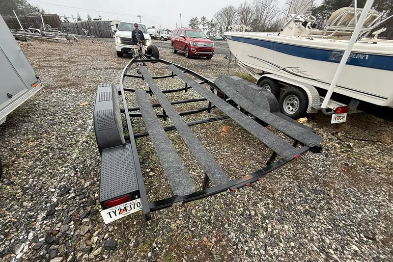 Slide: The Image of Boat trailer for 1997 Four Winns 238 Vista on gravel lot, overcast day. - 24