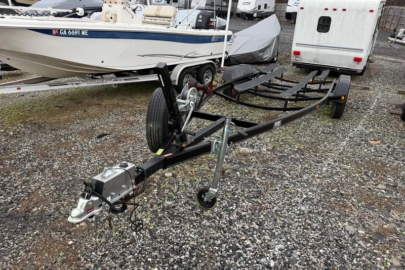 Slide: The Image of Boat trailer and Four Winns 238 Vista, 1997 model, parked on gravel lot. - 25