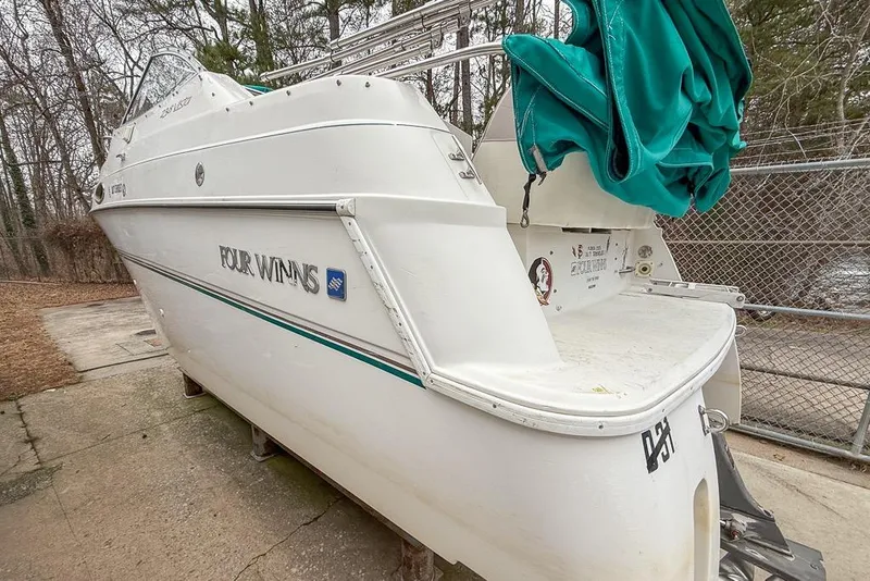 Slide: The Image of 1997 Four Winns 238 Vista boat, white exterior, docked outdoors with green cover. - 3