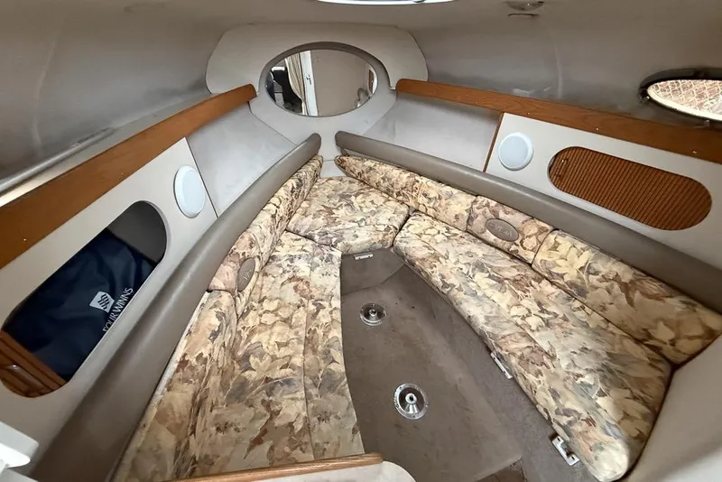 Slide: The Image of 1997 Four Winns 238 Vista boat interior with floral-patterned seating and wood accents. - 6