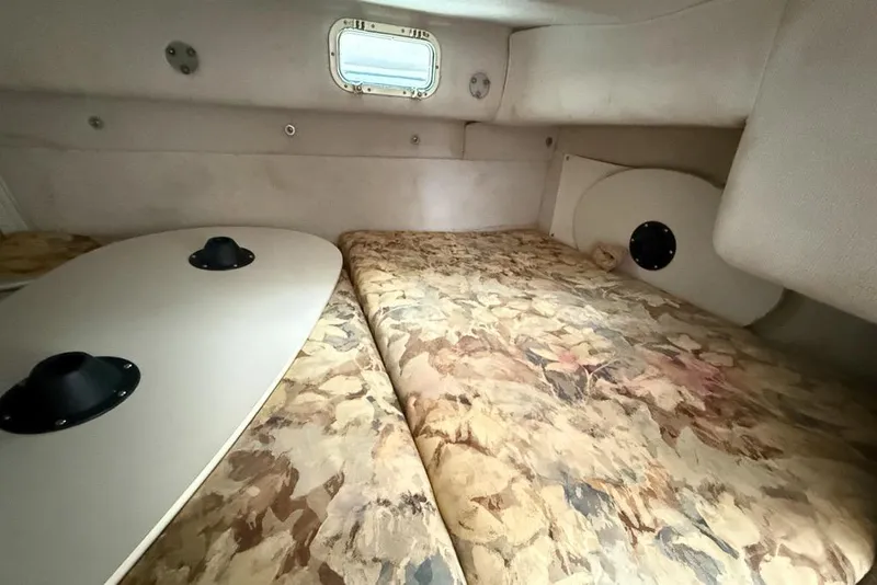 Slide: The Image of Interior cabin of 1997 Four Winns 238 Vista boat with floral-patterned bedding. - 8