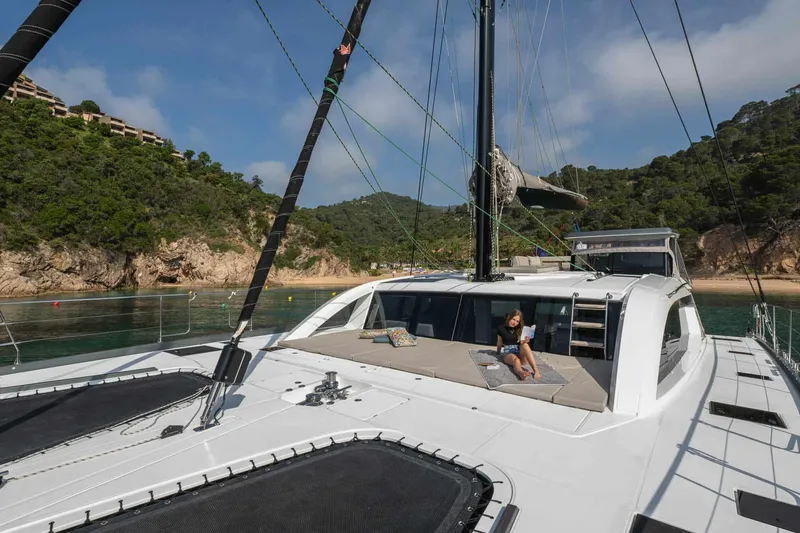 Slide: The Image of Luxury Privilege Signature 580 yacht anchored near scenic coastline, 2025 model. - 10