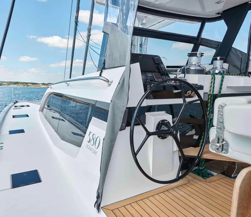 Slide: The Image of Luxury Privilege Signature 580 yacht helm, 2025 model, on open water. - 14