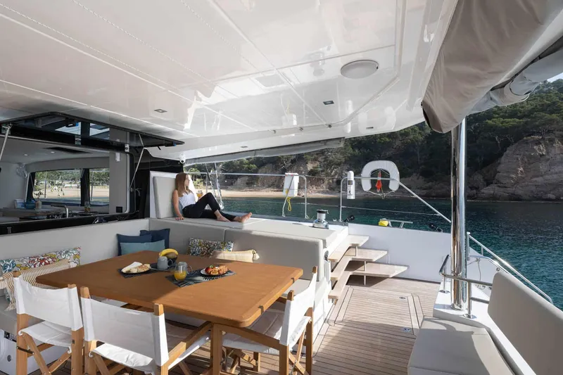 Slide: The Image of Luxurious 2025 Privilege Signature 580 yacht with elegant outdoor dining area and scenic ocean view. - 22