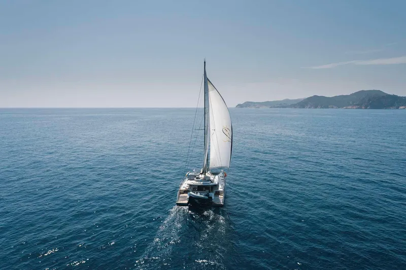 Slide: The Image of Sailing catamaran Privilege Signature 580, 2025 model, cruising on open sea. - 8