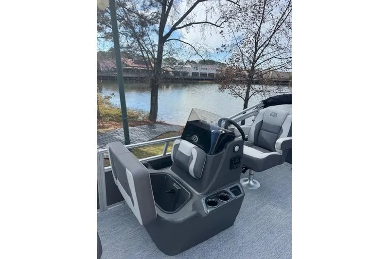 Slide: The Image of 2026 Sun Tracker Bass Buggy 16 XL Select pontoon boat interior with steering console and seating. - 12