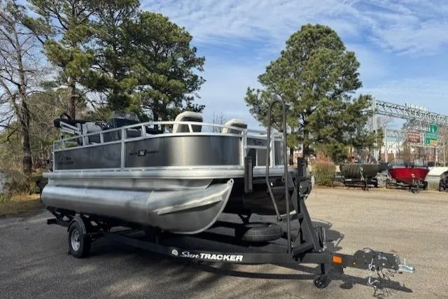 Slide: The Image of 2026 Sun Tracker Bass Buggy 16 XL Select on trailer outdoors. - 2