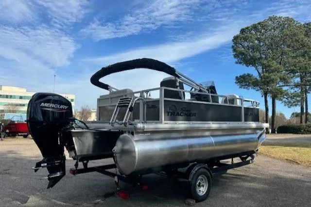 Slide: The Image of 2026 Sun Tracker Bass Buggy 16 XL Select pontoon boat with Mercury engine on trailer. - 3