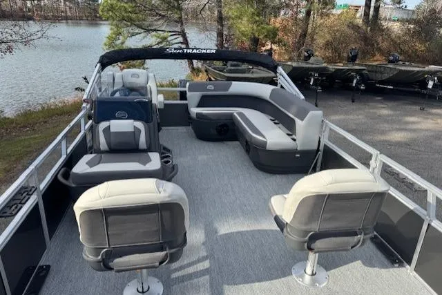 Slide: The Image of 2026 Sun Tracker Bass Buggy 16 XL Select pontoon boat with spacious seating on a serene lake. - 6