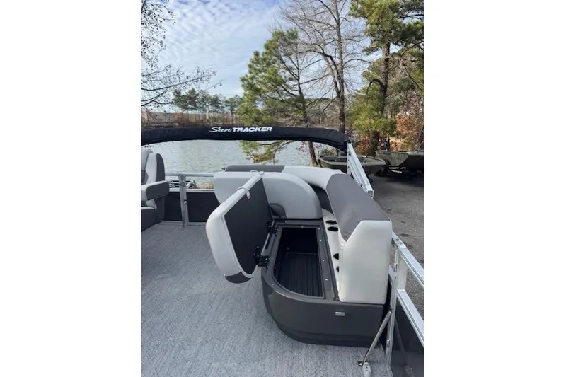 Slide: The Image of 2026 Sun Tracker Bass Buggy 16 XL Select pontoon boat with open storage compartment. - 9
