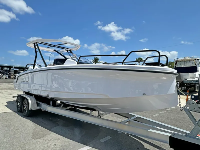 Slide: The Image of 2024 Axopar 25 Cross Top boat on trailer under clear blue sky. - 3