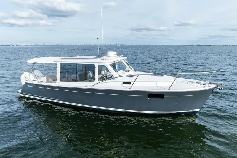 The Image of 2025 MJM 35 boat on calm ocean waters under a cloudy sky. - 0