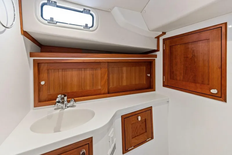 Slide: The Image of 2025 MJM 35 yacht bathroom with wooden cabinets and modern sink design. - 10