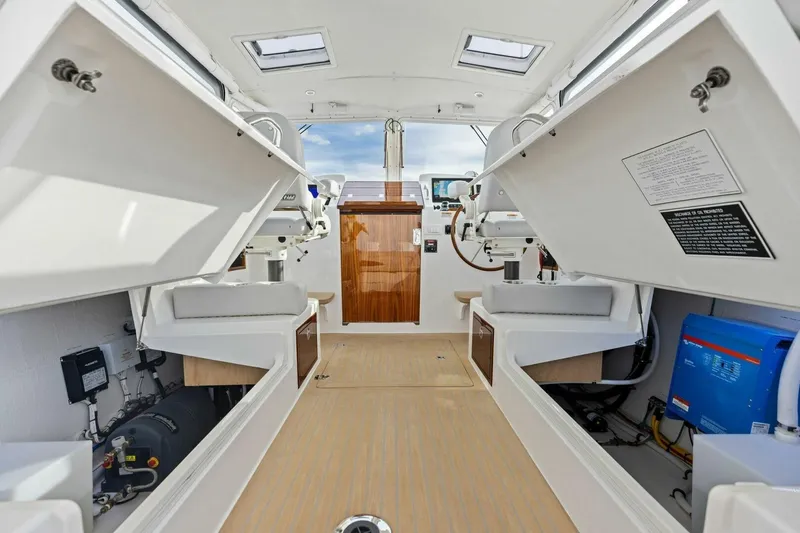Slide: The Image of Interior view of 2025 MJM 35 boat showcasing seating and equipment storage. - 14