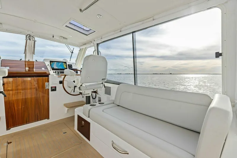 Slide: The Image of Interior of 2025 MJM 35 boat with helm, seating, and ocean view. - 17