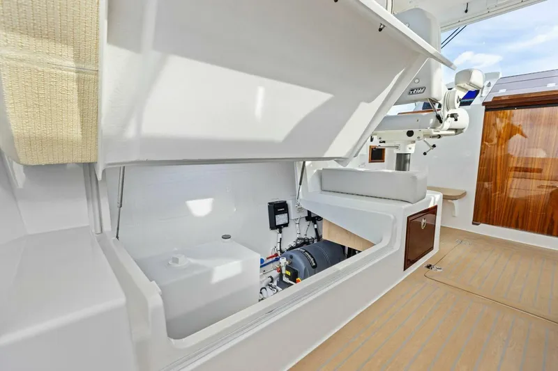 Slide: The Image of 2025 MJM 35 yacht interior storage compartment with open hatch and visible equipment. - 33