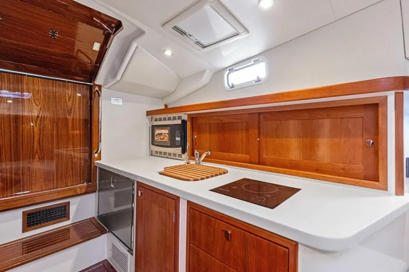 Slide: The Image of Modern galley kitchen in 2025 MJM 35 boat with wood accents and sleek appliances. - 8