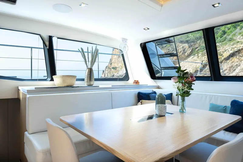 Slide: The Image of Luxurious interior of 2025 Privilege Signature 580 yacht with elegant dining area and scenic views. - 41