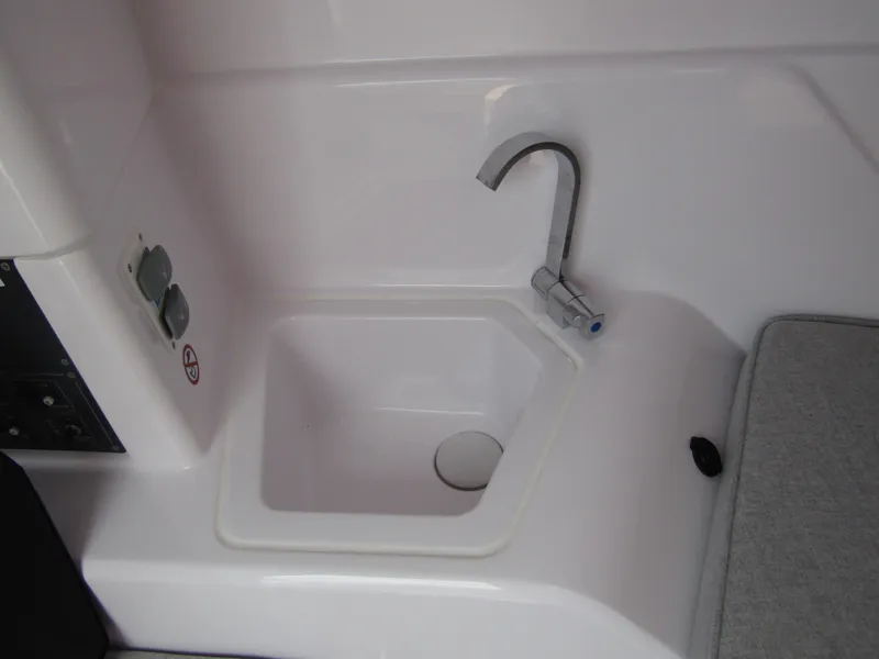 Slide: The Image of Compact sink area in the 2024 Axopar 25 Cross Top boat. - 22