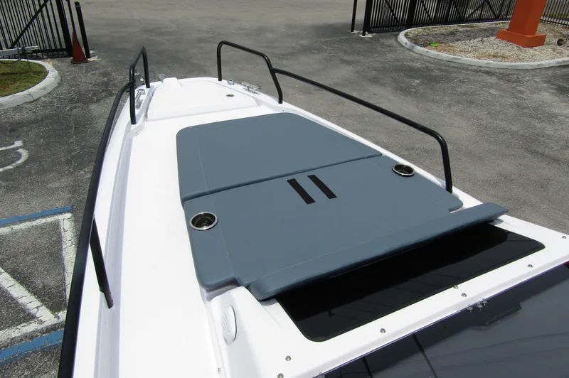Slide: The Image of 2024 Axopar 25 Cross Top boat deck with gray sun pad and railings. - 10