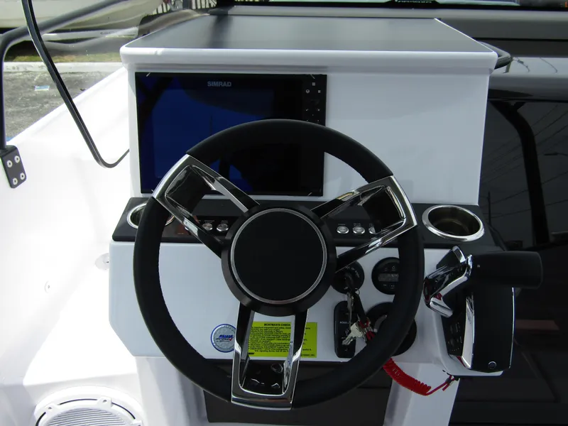Slide: The Image of 2024 Axopar 25 Cross Top boat steering console with modern controls and navigation display. - 14