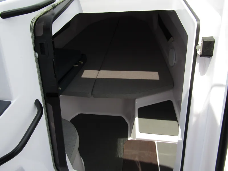 Slide: The Image of Interior cabin of 2024 Axopar 25 Cross Top boat with cushioned seating. - 20