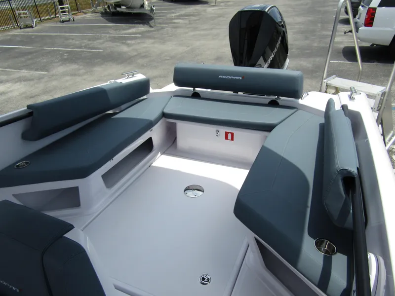 Slide: The Image of 2024 Axopar 25 Cross Top boat interior with cushioned seating and storage compartments. - 25