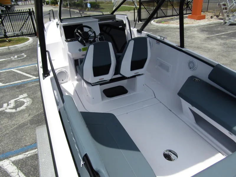 Slide: The Image of 2024 Axopar 25 Cross Top boat interior with dual seats and modern dashboard. - 31