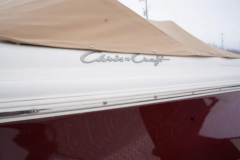 Slide: The Image of 2015 Chris-Craft Lancer 20 boat with beige cover and logo detail. - 10