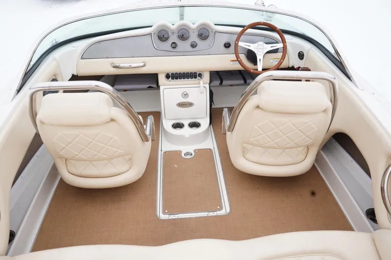 Slide: The Image of 2015 Chris-Craft Lancer 20 interior with beige seats and wooden steering wheel. - 11