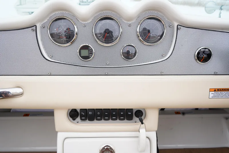 Slide: The Image of Dashboard of 2015 Chris-Craft Lancer 20 boat with gauges and controls. - 12