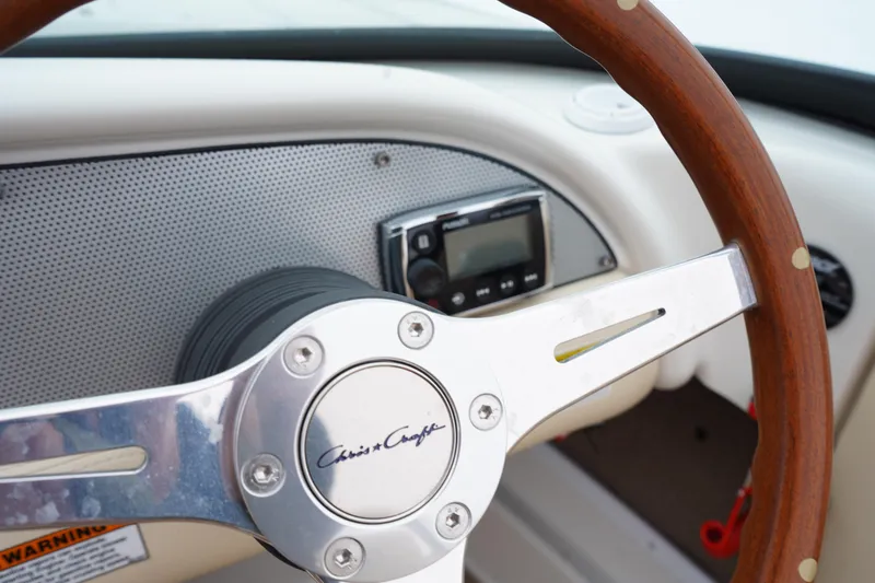Slide: The Image of 2015 Chris-Craft Lancer 20 steering wheel and dashboard close-up. - 14
