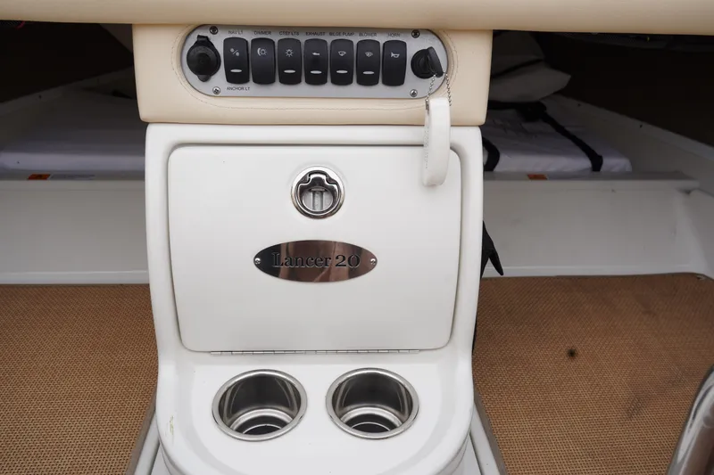 Slide: The Image of 2015 Chris-Craft Lancer 20 boat interior with control panel and cup holders. - 16