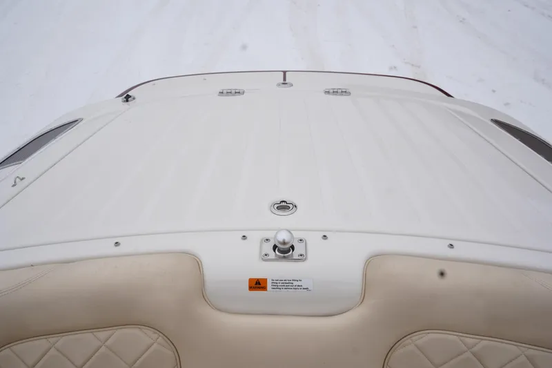 Slide: The Image of 2015 Chris-Craft Lancer 20 boat deck with beige seating and white finish. - 26