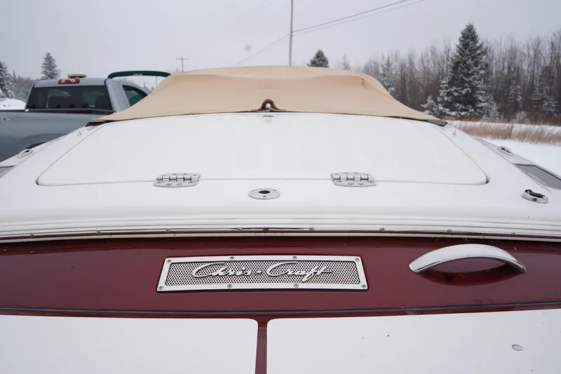 Slide: The Image of 2015 Chris-Craft Lancer 20 boat with beige cover in snowy landscape. - 4