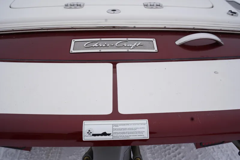 Slide: The Image of 2015 Chris-Craft Lancer 20 boat stern with logo and safety warning label. - 5