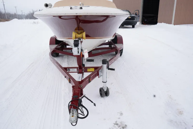 Slide: The Image of 2015 Chris-Craft Lancer 20 boat on trailer in snowy setting. - 7