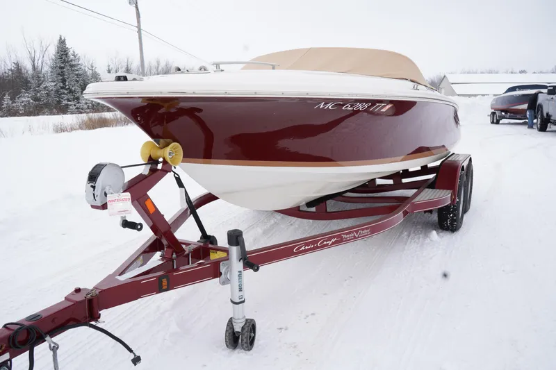 Slide: The Image of 2015 Chris-Craft Lancer 20 boat on trailer in snowy landscape. - 8