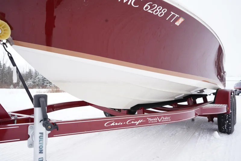 Slide: The Image of 2015 Chris-Craft Lancer 20 boat on trailer in snowy landscape. - 9