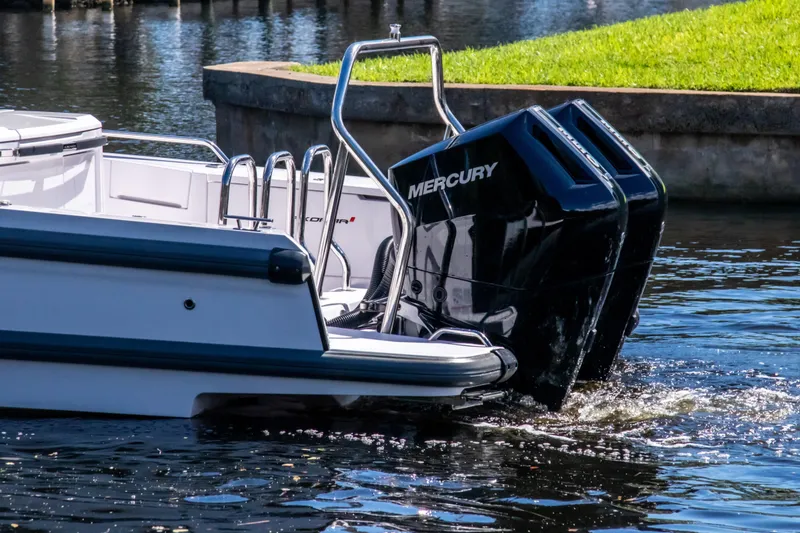 Slide: The Image of 2024 Axopar 37 Sun Top with dual Mercury outboard engines on water. - 35