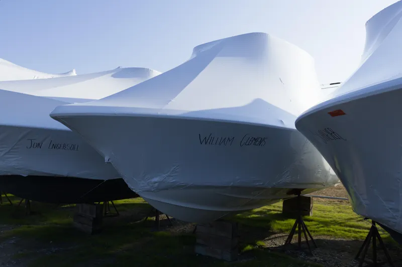 The Image of 2017 Key West 219 FS boats covered and stored on stands outdoors. - 0