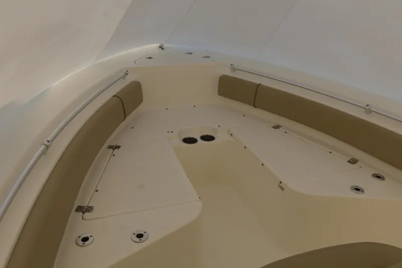 Slide: The Image of 2017 Key West 219 FS boat interior with beige seating and storage compartments. - 2