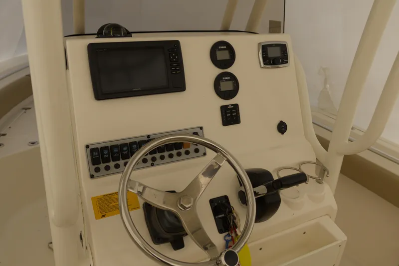 Slide: The Image of 2017 Key West 219 FS boat dashboard with steering wheel and navigation controls. - 4