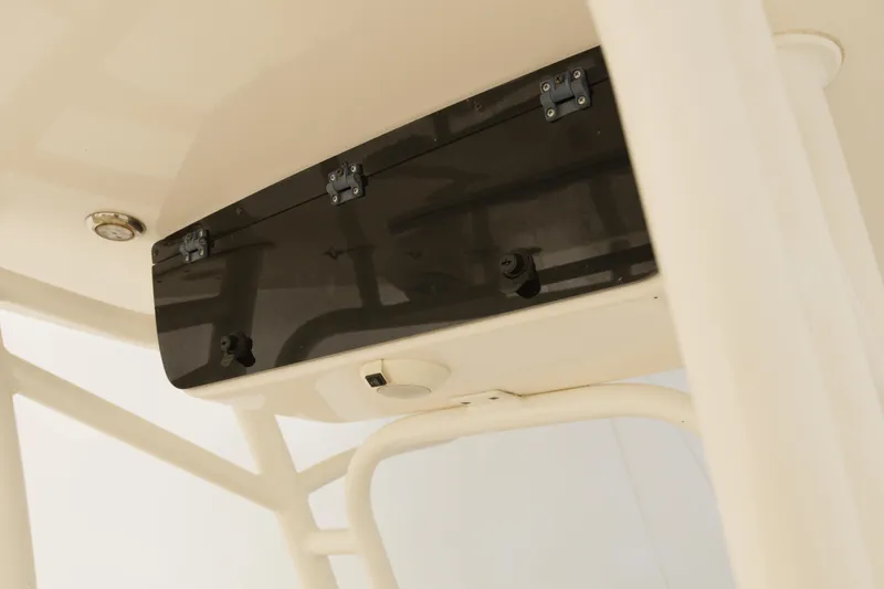 Slide: The Image of 2017 Key West 219 FS boat console detail with storage compartment and hinges. - 7
