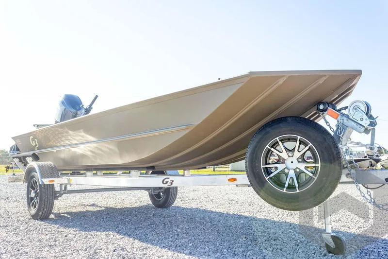 Slide: The Image of 2026 G3 Gator Tough 1652 VBW boat on trailer, side view, sunny day. - 13