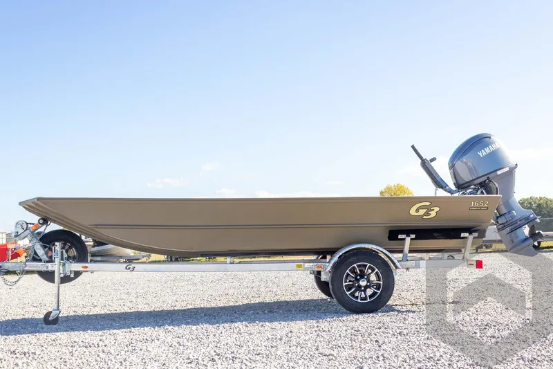 Slide: The Image of 2026 G3 Gator Tough 1652 VBW boat on trailer, side view, outdoors. - 18
