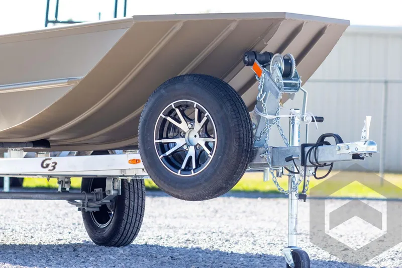 Slide: The Image of 2026 G3 Gator Tough 1652 VBW boat on trailer, close-up of wheel and hitch. - 4