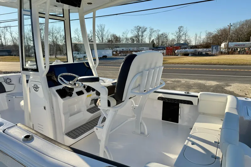 Slide: The Image of 2026 Tidewater 220 LXF boat interior with helm, seating, and steering wheel. - 13
